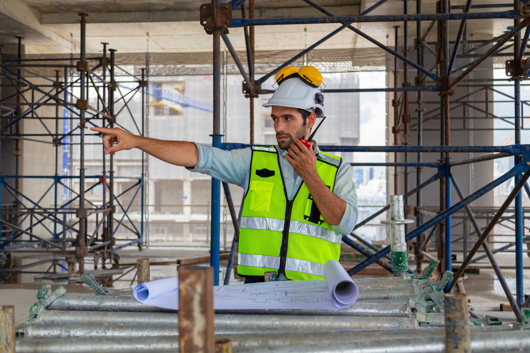 Portrait of an engineer designing a large project, checking the job site to meet the specification.